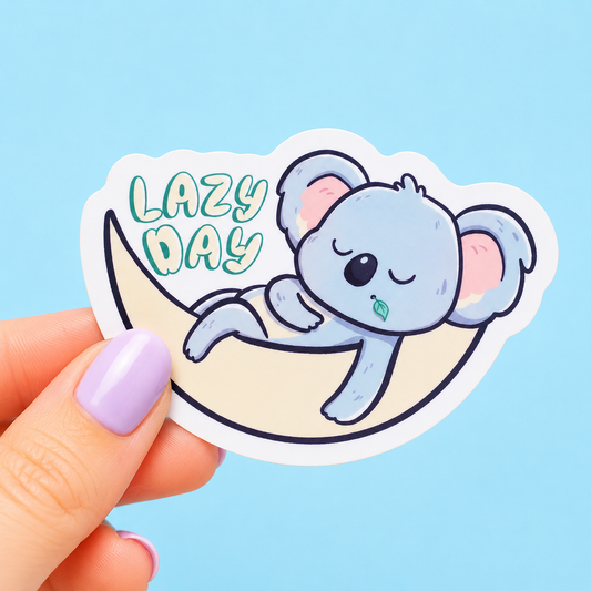 Sleazy Greetings cute die-cut vinyl sticker featuring a sleepy koala lounging in a hammock beside the phrase ‘Lazy Day.’ Cozy kawaii-style animal sticker with soft pastel artwork, peaceful nap vibes, and professional relaxation energy.