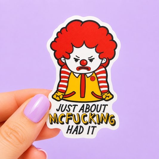 Sleazy Greetings funny die-cut vinyl sticker featuring an angry fast-food clown parody beside the phrase ‘Just About McFucking Had It.’ Sarcastic cartoon sticker with bold humor, frustrated expression, and playful parody-inspired aesthetic.