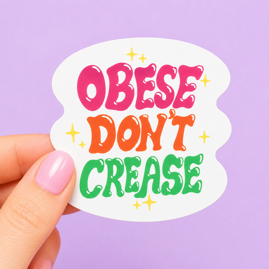 Sleazy Greetings funny die-cut vinyl sticker featuring bold retro bubble lettering that says ‘Obese Don’t Crease.’ Chaotic body-positive sticker with playful Y2K-inspired typography, aggressively comfy energy, and unapologetically thick gremlin vibes.