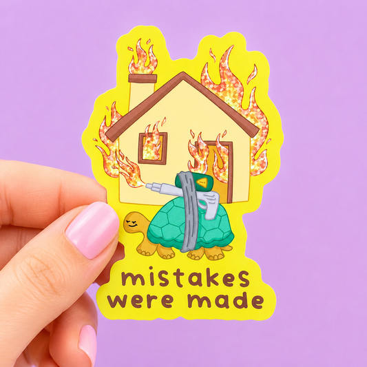 Sleazy Greetings funny holographic vinyl sticker featuring a calm cartoon turtle carrying a flamethrower while a house burns behind it beside the phrase ‘Mistakes Were Made.’ Chaotic absurd humor sticker with glittery flames, cute animal artwork, and playful disaster aesthetic.
