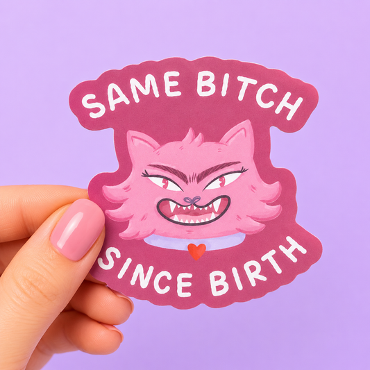 Sleazy Greetings funny die-cut vinyl sticker featuring a feral pink cat with unhinged eyebrows beside the phrase ‘Same Bitch Since Birth.’ Chaotic gremlin cat sticker with bold pastel artwork, aggressively authentic energy, and zero personal-growth vibes.