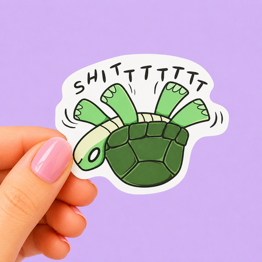 Sleazy Greetings funny die-cut vinyl sticker featuring a panicked upside-down turtle flailing beside the phrase ‘Shitttttt.’ Cute chaotic animal sticker with relatable disaster energy, playful cartoon artwork, and aggressively overwhelmed little gremlin vibes.