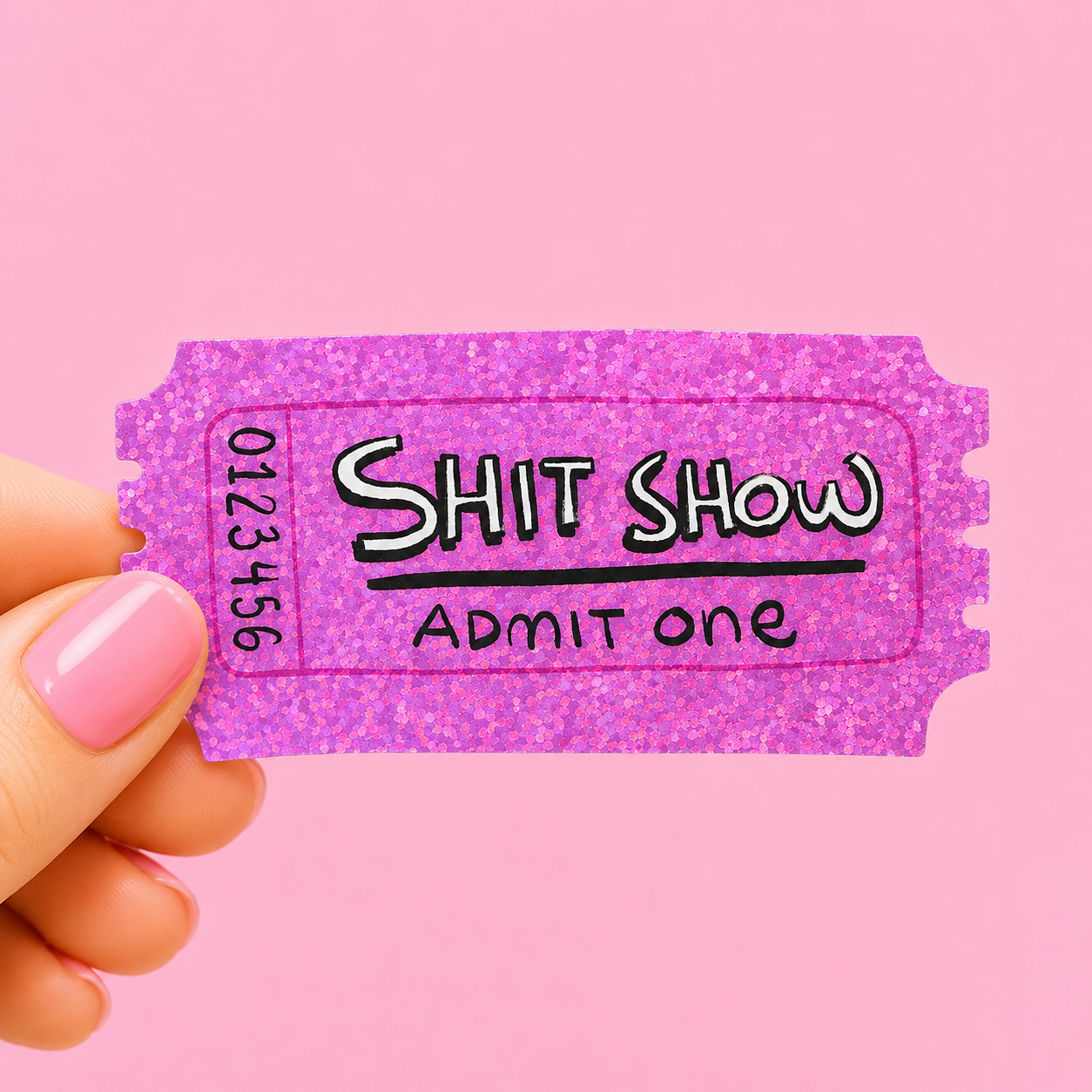 Sleazy Greetings funny die-cut vinyl sticker designed like a glittery event ticket featuring the phrase ‘Shit Show – Admit One.’ Relatable chaos humor sticker with sparkly pink aesthetic, playful typography, and messy life energy.