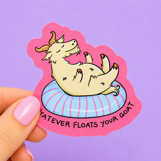 Sleazy Greetings funny die-cut vinyl sticker featuring a relaxed cartoon goat floating on an inflatable pool tube beside the phrase ‘Whatever Floats Your Goat.’ Cute animal pun sticker with pastel pink background, whimsical summer vibes, and playful humor aesthetic.