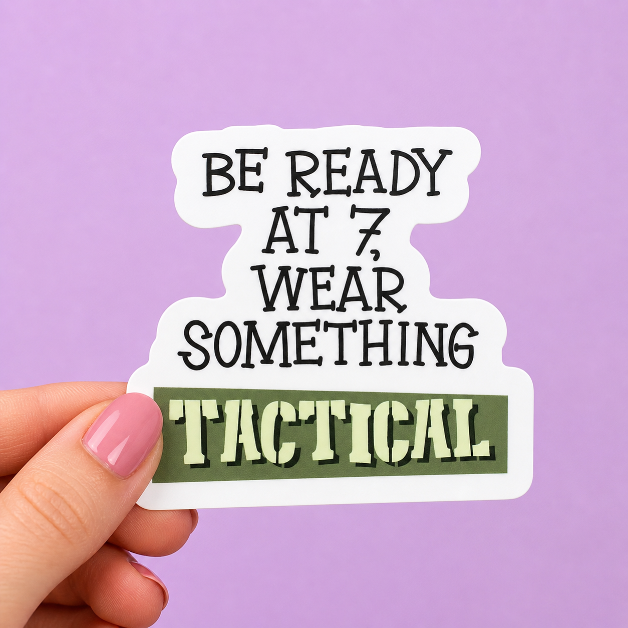 Sleazy Greetings funny die-cut vinyl sticker featuring bold chaotic lettering that says ‘Be Ready at 7, Wear Something Tactical.’ Absurd meme-style sticker with aggressively unserious threat energy, playful typography, and chaotic gremlin-planning vibes.