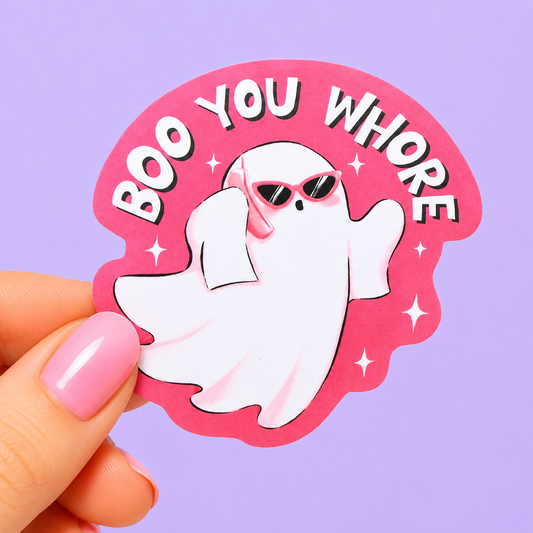 Sleazy Greetings funny die-cut vinyl sticker featuring a fashionable ghost in sunglasses beside the phrase ‘Boo You Whore.’ Chaotic spooky-girl sticker with playful pastel aesthetics, aggressively sassy energy, and glamorous little gremlin vibes.