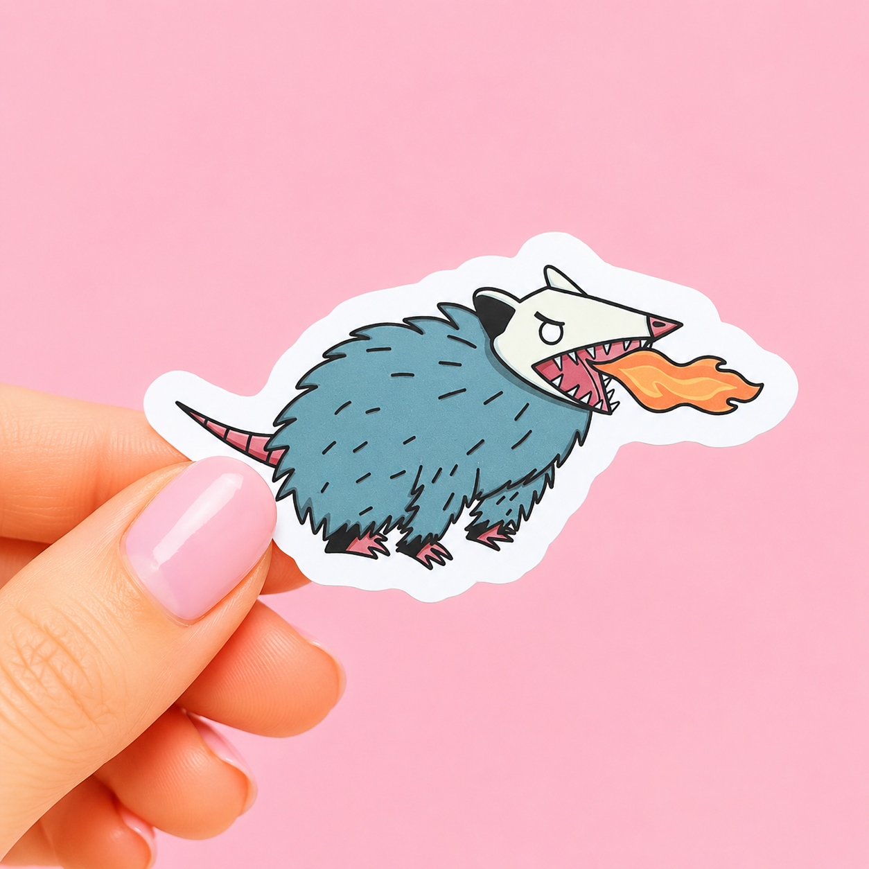 Sleazy Greetings funny die-cut vinyl sticker featuring a feral possum breathing fire like a tiny trash-dragon. Chaotic gremlin animal sticker with aggressive menace energy, scruffy cartoon artwork, and emotionally unstable little goblin vibes.