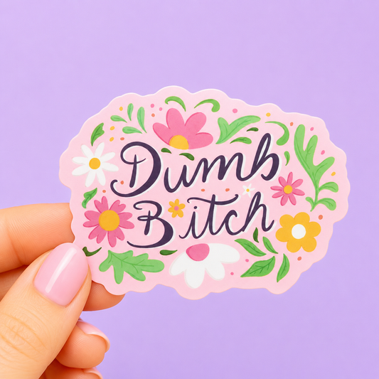 Sleazy Greetings funny die-cut vinyl sticker featuring the phrase ‘Dumb Bitch’ surrounded by colorful floral illustrations on a pastel pink background. Cute sarcastic sticker with playful hand-lettered typography and cheerful retro flower aesthetic.