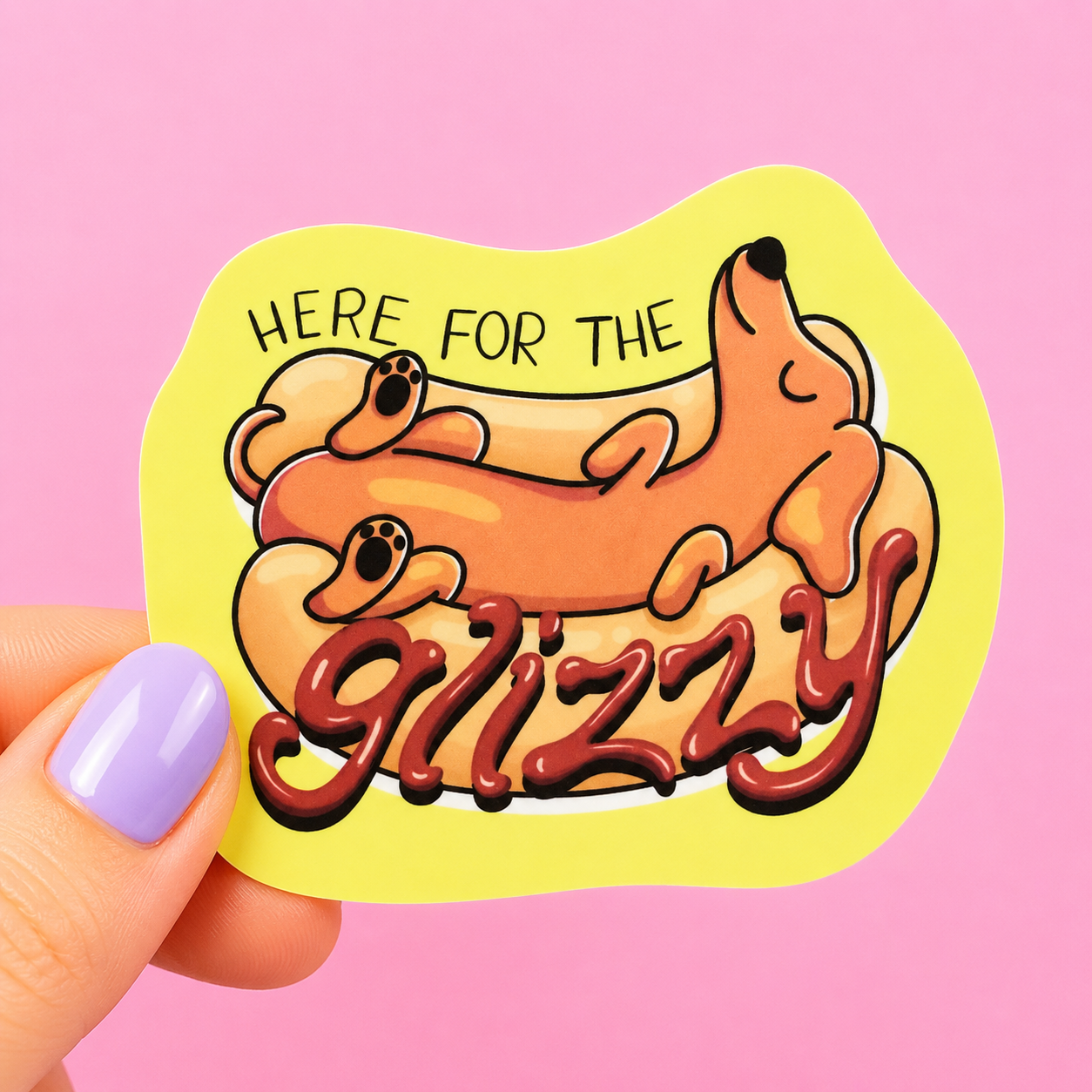 Sleazy Greetings funny die-cut vinyl sticker featuring a relaxed wiener dog lounging in a hot dog bun beside the phrase ‘Here for the Glizzy.’ Cute chaotic food-and-dog sticker with meme-inspired humor, playful cartoon artwork, and unapologetically snack-loving energy.