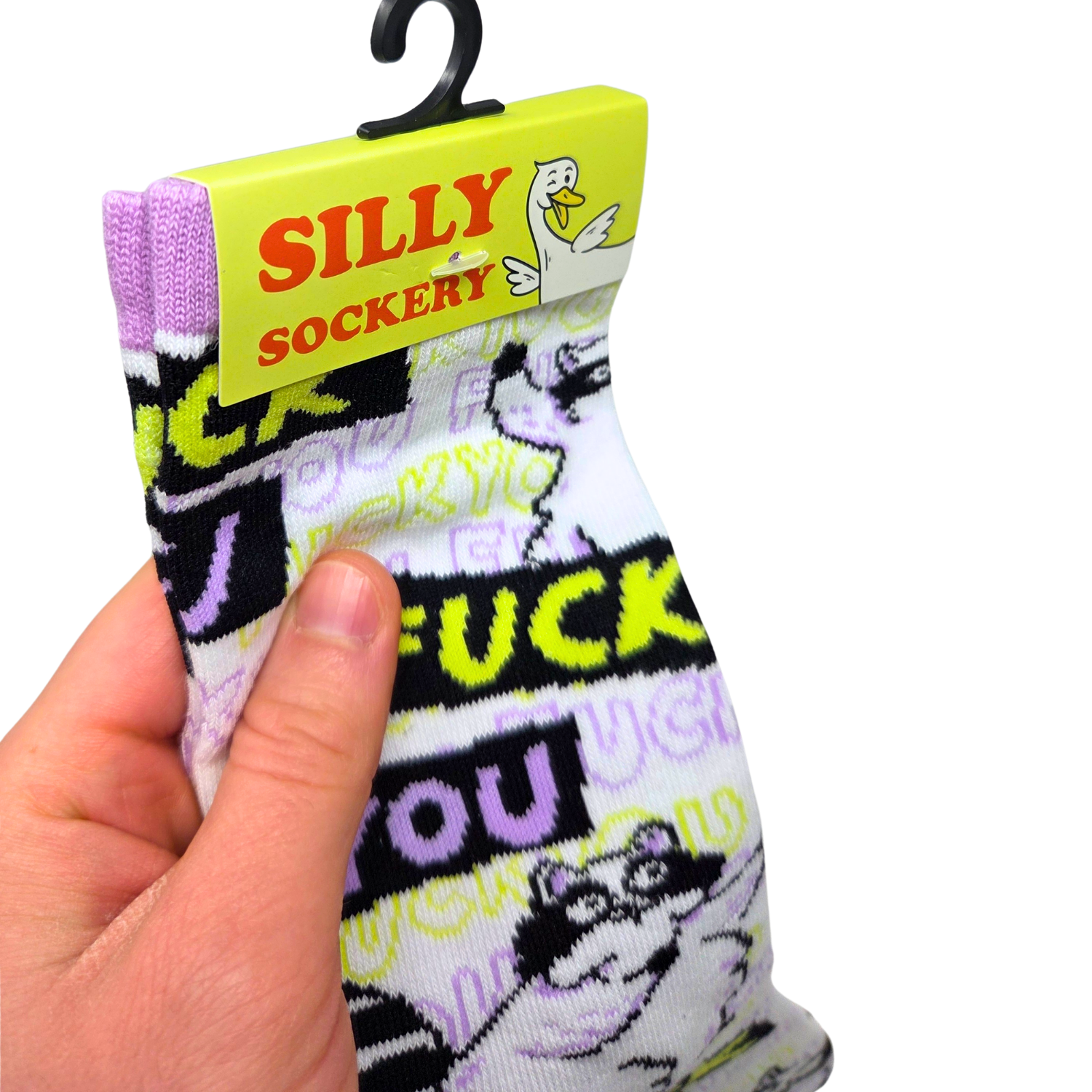 Sleazy Greetings novelty crew socks featuring grumpy cartoon raccoons and repeated ‘Fuck You’ typography in bold black, neon yellow, lavender, and white colors. Funny sarcastic statement socks with chaotic meme-inspired artwork and edgy humorous style.