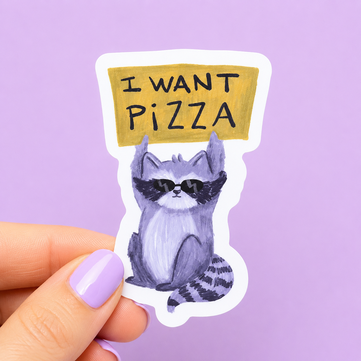 Sleazy Greetings funny die-cut vinyl sticker featuring a cool raccoon wearing sunglasses and holding a sign that says ‘I Want Pizza.’ Cute chaotic trash-panda sticker with relatable snack-goblin energy, playful pastel artwork, and aggressively hungry vibes.