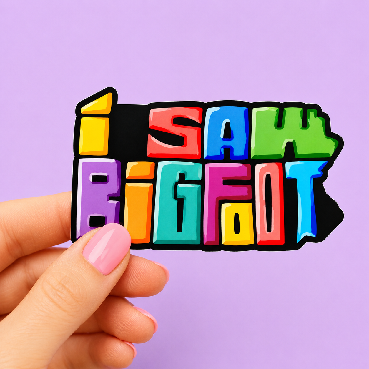 Sleazy Greetings funny die-cut vinyl sticker featuring bold rainbow block lettering spelling ‘I Saw Bigfoot.’ Colorful cryptid humor sticker with retro cartoon typography, playful paranormal vibes, and vibrant glossy aesthetic.