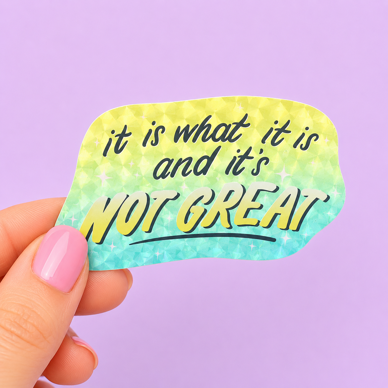 Sleazy Greetings funny die-cut vinyl sticker featuring sparkly retro lettering that says ‘It Is What It Is and It’s Not Great.’ Chaotic existential sticker with relatable burnout humor, glittery Y2K-inspired aesthetics, and aggressively coping gremlin energy.