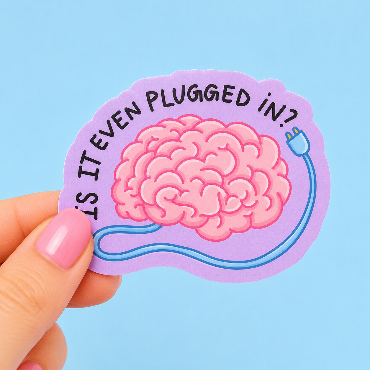 Sleazy Greetings funny die-cut vinyl sticker featuring a cartoon brain with a power cord beside the phrase ‘Is It Even Plugged In?’ Cute sarcastic sticker with pastel purple background, playful mental exhaustion humor, and whimsical aesthetic.