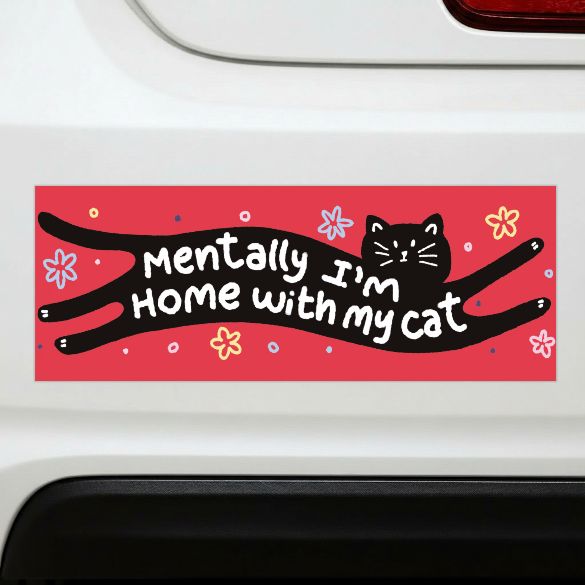 Sleazy Greetings funny bumper magnet featuring the phrase ‘Mentally I’m Home With My Cat’ integrated into a stretched black cat illustration on a bright red background with playful flowers and doodles. Humorous novelty car magnet with cozy introvert humor, whimsical pet lover aesthetic, and cute cartoon artwork.