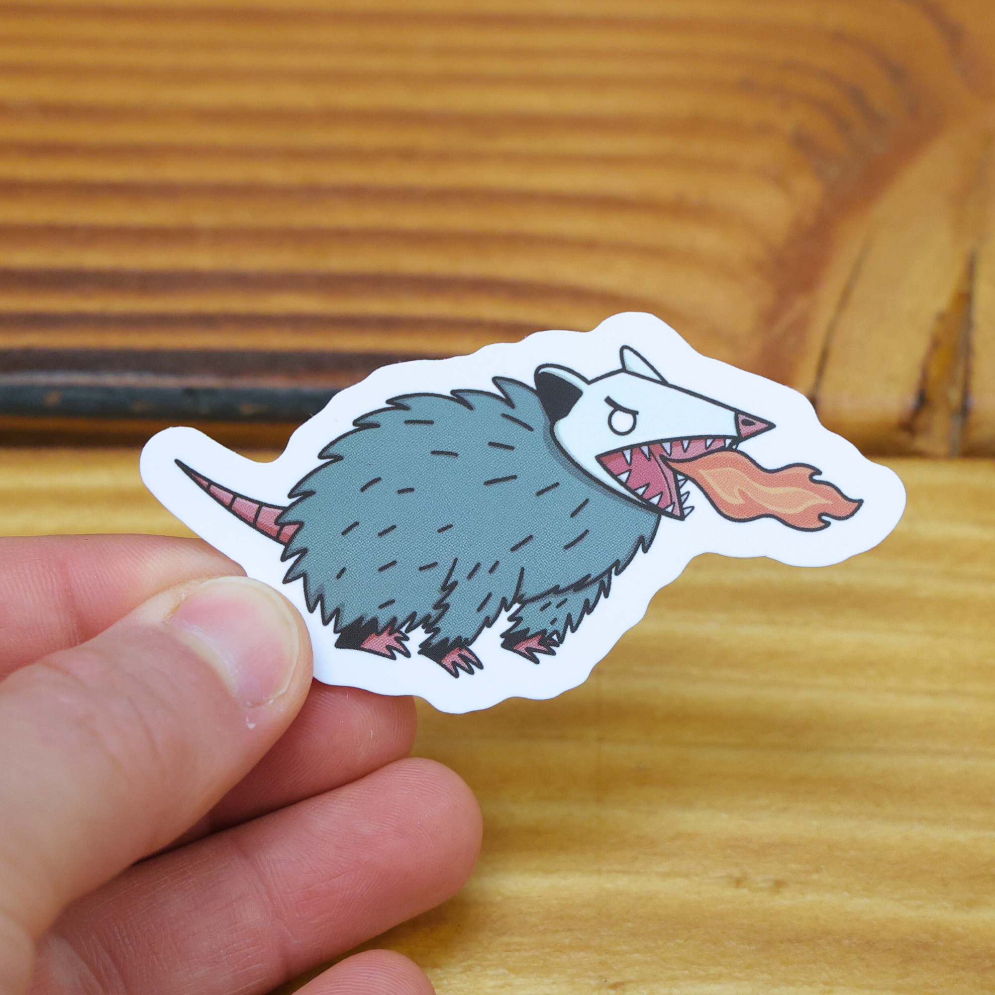 Crude Opossum Breathing Fire Sticker