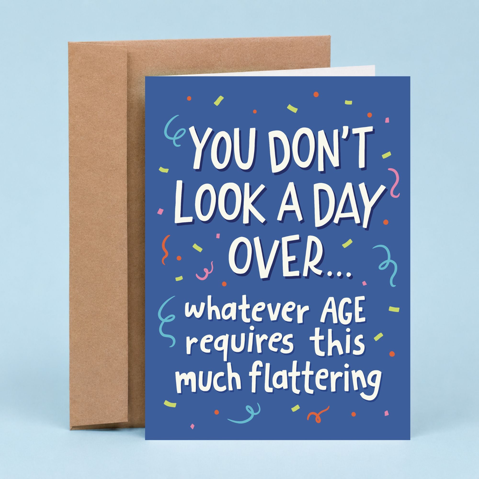 Sleazy Greetings funny birthday card featuring a blue background with colorful confetti and the phrase, “You Don't Look a Day Over... Whatever Age Requires This Much Flattering.” Sarcastic birthday greeting card perfect for friends, family, coworkers, and anyone celebrating another year.