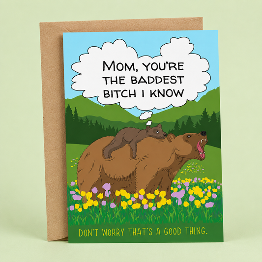 Sleazy Greetings funny Mother’s Day card featuring a mama bear carrying her cub through a colorful wildflower meadow with mountains in the background. The card reads, “Mom, You’re the Baddest Bitch I Know,” followed by, “Don’t Worry That’s a Good Thing,” creating a humorous and empowering Mother’s Day message. Displayed with a kraft envelope, this funny card is perfect for moms with a strong personality, great sense of humor, and fierce protective instincts.
