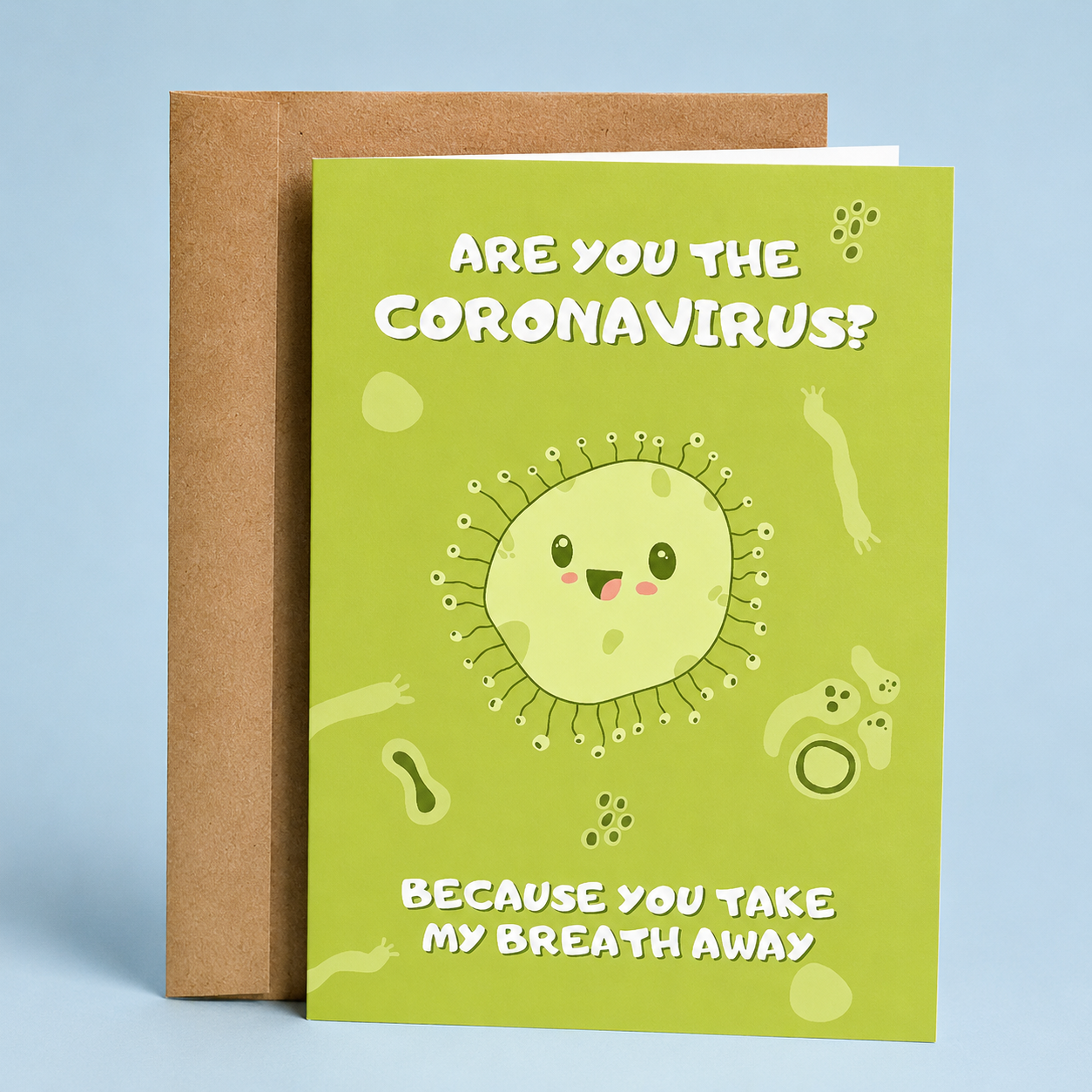 Sleazy Greetings funny love card featuring a cute cartoon coronavirus character on a green background surrounded by playful microbe illustrations. The card reads, “Are You the Coronavirus? Because You Take My Breath Away,” delivering a cheeky pandemic-inspired pickup line and romantic joke. Displayed with a kraft envelope, this humorous card is perfect for a boyfriend, girlfriend, husband, wife, partner, Valentine’s Day, anniversary, or anyone who appreciates quirky nerdy humor.