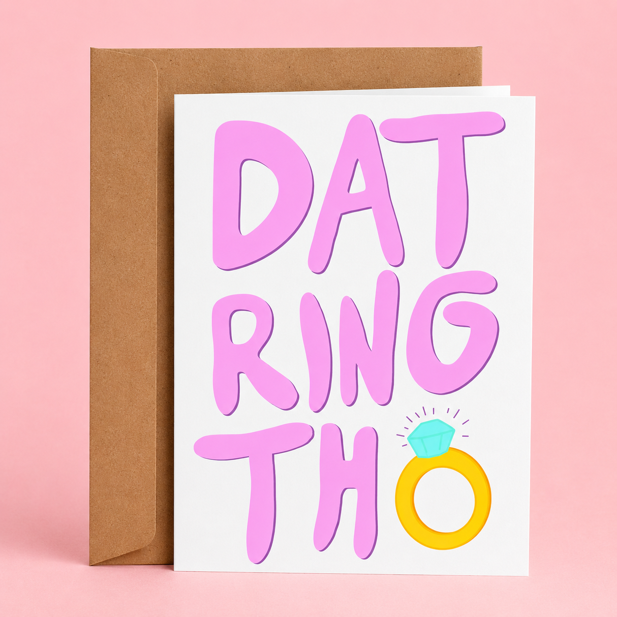 Sleazy Greetings funny engagement card featuring oversized pink lettering that reads, “DAT RING THO,” with a sparkling diamond ring illustration replacing the letter O. A humorous congratulations card for newly engaged couples, displayed with a kraft envelope against a soft pink background.
