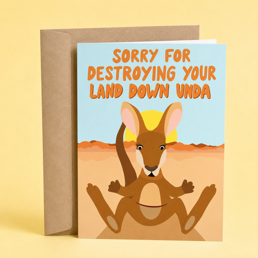 Sleazy Greetings funny apology card featuring a kangaroo sitting in the Australian outback at sunset on a light blue background. The card reads, “Sorry for Destroying Your Land Down Unda,” making a cheeky Australia-themed pun and apology joke, and is displayed with a kraft envelope against a soft yellow backdrop.