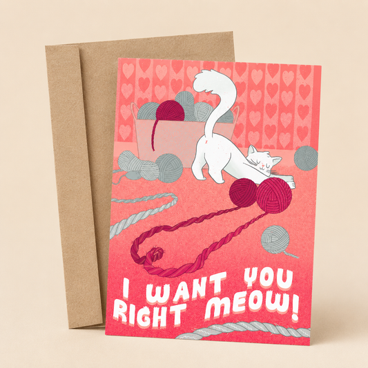 Sleazy Greetings funny cat love card featuring a mischievous white cat playing with balls of yarn in a pink room filled with knitting supplies. The card reads, “I Want You Right Meow!” and is displayed with a kraft envelope.