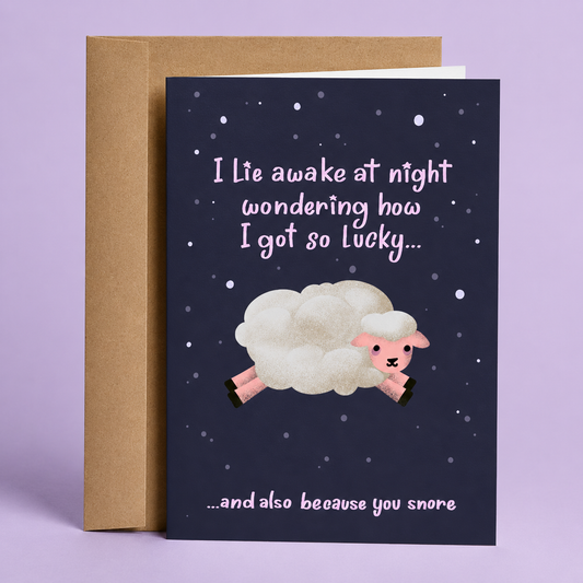 Sleazy Greetings funny love card featuring an adorable fluffy sheep jumping across a starry night sky on a dark purple background. The card reads, “I Lie Awake at Night Wondering How I Got So Lucky... and Also Because You Snore,” combining sweet romance with relatable relationship humor. Displayed with a kraft envelope, this cute and sarcastic card is perfect for a boyfriend, girlfriend, husband, wife, partner, Valentine’s Day, anniversaries, or anyone who appreciates playful jokes about life together.