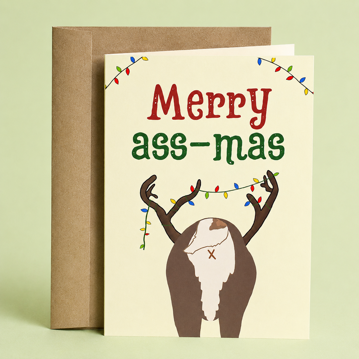 Sleazy Greetings funny Christmas card featuring the backside of a reindeer with colorful Christmas lights tangled around its antlers. The card reads, “Merry Ass-mas,” blending holiday cheer with playful adult humor and a festive pun. Displayed with a kraft envelope, this humorous Christmas greeting card is perfect for friends, coworkers, family members, Secret Santa exchanges, white elephant parties, and anyone who enjoys sarcastic holiday humor.