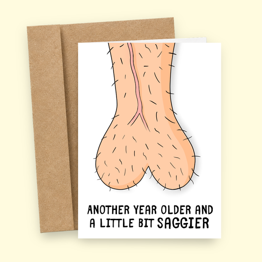 Sleazy Greetings funny birthday card featuring a pair of hilariously saggy balls and the phrase “Another Year Older and a Little Bit Saggier,” a laugh-out-loud birthday card for husbands, boyfriends, brothers, dads, coworkers, best friends, or any guy with a great sense of humor who can appreciate getting older, gravity doing its thing, and another year of questionable body maintenance.
