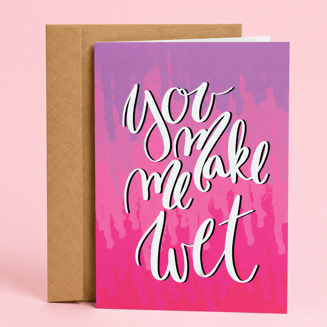 Sleazy Greetings funny adult love greeting card featuring elegant hand-lettered typography on a pink and purple watercolor background with the cheeky message “You Make Me Wet,” displayed with a kraft envelope for a humorous anniversary, Valentine’s Day, boyfriend, girlfriend, husband, wife, or romantic greeting card.