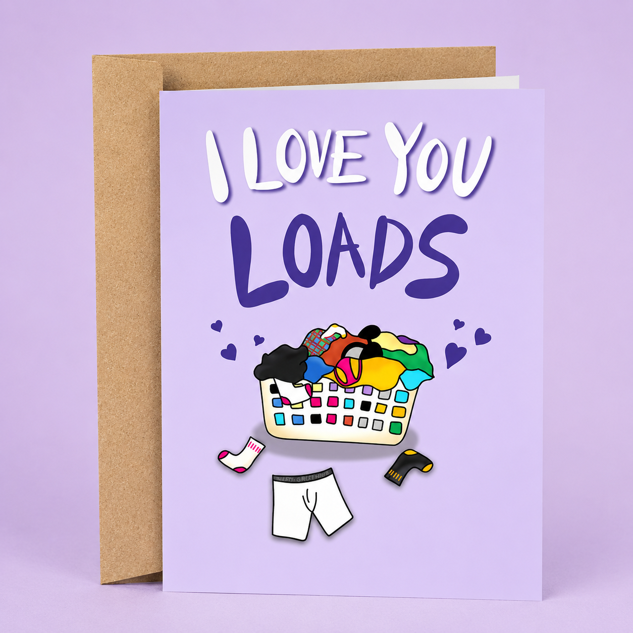 Sleazy Greetings funny love card featuring an overflowing laundry basket and the phrase “I Love You Loads,” a humorous and heartfelt Valentine's Day, anniversary, wedding, engagement, or just-because card for husbands, wives, boyfriends, girlfriends, partners, fiancés, or anyone who deserves to know they’re loved more than a mountain of dirty laundry.