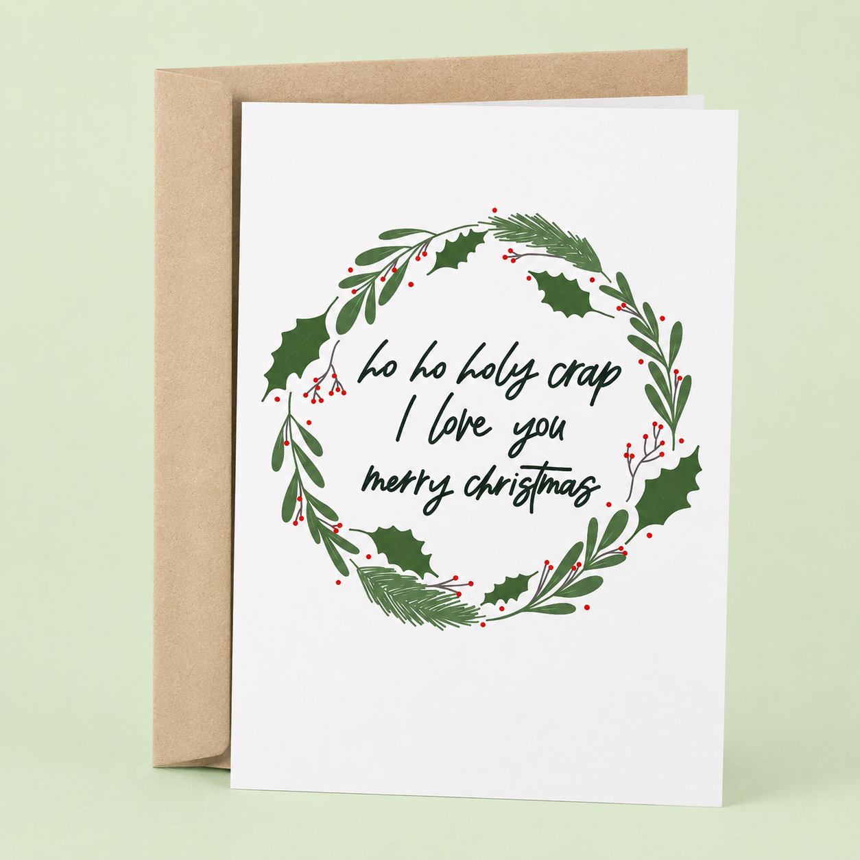 Sleazy Greetings romantic Christmas greeting card featuring a festive holiday wreath and the phrase “Ho Ho Holy Crap I Love You, Merry Christmas,” a sweet and funny holiday card for boyfriend, girlfriend, husband, wife, partner, fiancée, or anyone who makes Christmas extra special.