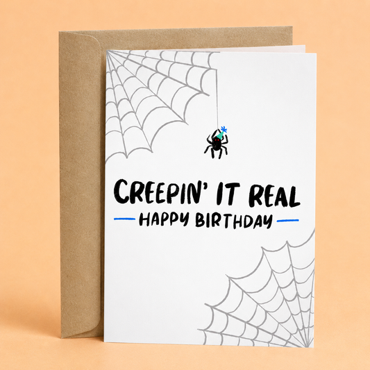 Sleazy Greetings funny Halloween birthday card featuring a spider, cobwebs, and the phrase “Creepin’ It Real, Happy Birthday,” a humorous spooky birthday card for Halloween lovers, friends, family, coworkers, or anyone who enjoys creepy-cute birthday humor.