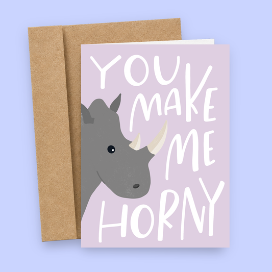 Sleazy Greetings funny love greeting card featuring a rhinoceros illustration and the phrase “You Make Me Horny,” a humorous Valentine's Day, anniversary, wedding, or romantic relationship card for boyfriend, girlfriend, husband, wife, or partner.