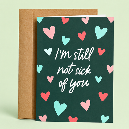Sleazy Greetings funny love greeting card featuring the phrase “I’m Still Not Sick of You” surrounded by colorful hearts, a humorous anniversary, Valentine’s Day, wedding, or romantic relationship card for boyfriend, girlfriend, husband, wife, or partner.