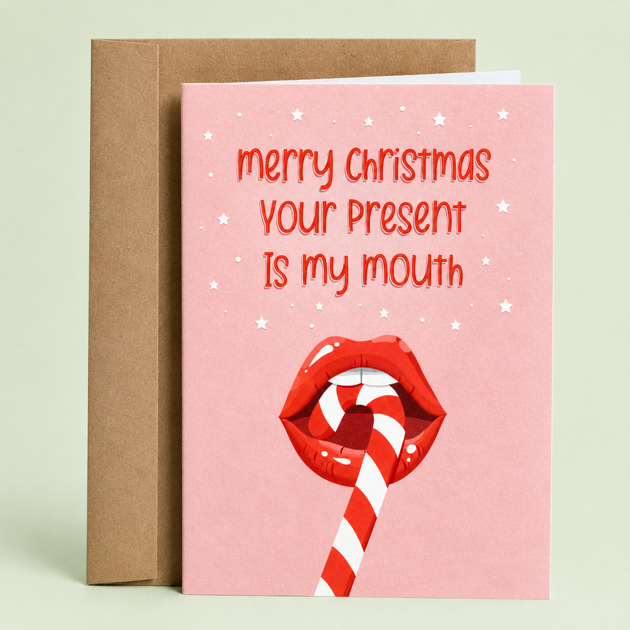 Sleazy Greetings funny adult Christmas card featuring red lips licking a candy cane with the phrase, “Merry Christmas, Your Present Is My Mouth.” Naughty holiday greeting card perfect for couples, spouses, partners, and lovers of cheeky Christmas humor.