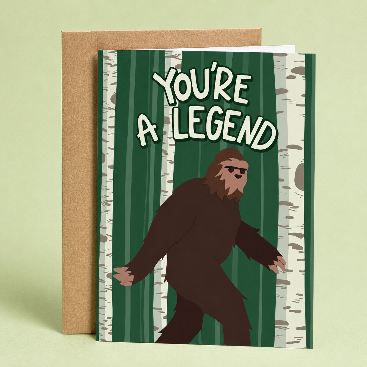 Sleazy Greetings funny Father’s Day greeting card featuring a Bigfoot illustration walking through a forest with the message “You’re a Legend,” displayed with a kraft envelope for a humorous and heartfelt Father’s Day gift.