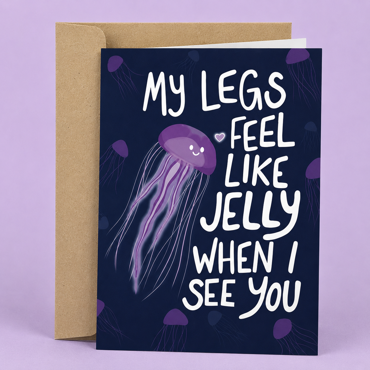 Sleazy Greetings funny love card featuring glowing purple jellyfish floating on a dark ocean background. The card reads, “My Legs Feel Like Jelly When I See You,” and is displayed with a kraft envelope.