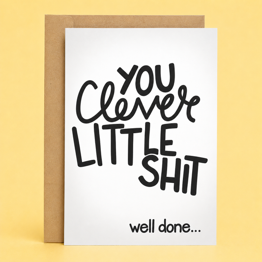 Sleazy Greetings funny encouragement card featuring bold black typography on a white background that reads, “You Clever Little Shit,” with the congratulatory message “Well Done...” underneath. Displayed with a kraft envelope.