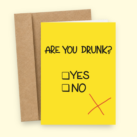 Sleazy Greetings funny drinking card featuring a bright yellow background with the question “Are You Drunk?” and checkbox options for “Yes” and “No.” A large red X misses both boxes, creating a humorous joke about being too drunk to complete the form. Displayed with a kraft envelope.