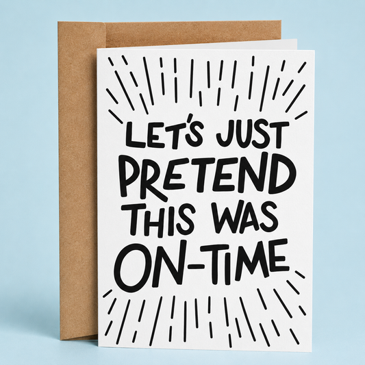 Sleazy Greetings funny belated card featuring bold black typography on a white background with decorative burst lines surrounding the message, “Let’s Just Pretend This Was On-Time.” Displayed with a kraft envelope.
