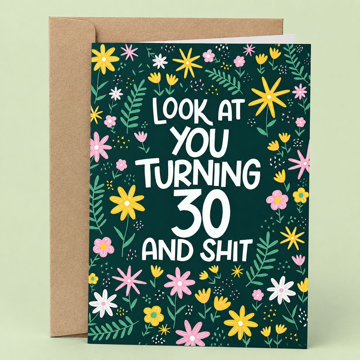 Sleazy Greetings funny 30th birthday card featuring a colorful floral pattern on a dark green background, with the sarcastic milestone birthday message “Look At You Turning 30 And Shit,” paired with a kraft envelope.