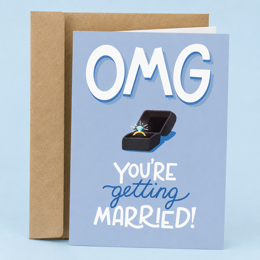 Sleazy Greetings funny engagement card featuring a sparkling diamond ring in an open ring box on a soft blue background, with the excited announcement “OMG You’re Getting Married!” paired with a kraft envelope.