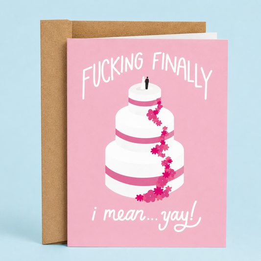 Sleazy Greetings funny wedding card featuring a tall pink-and-white wedding cake with a bride and groom topper on a blush pink background, with the sarcastic congratulations message “Fucking Finally... I Mean... Yay!” paired with a kraft envelope.