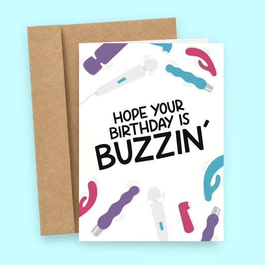 Sleazy Greetings funny adult birthday card featuring colorful vibrators and massage wands on a white background, with the cheeky message “Hope Your Birthday Is Buzzin’,” paired with a kraft envelope.