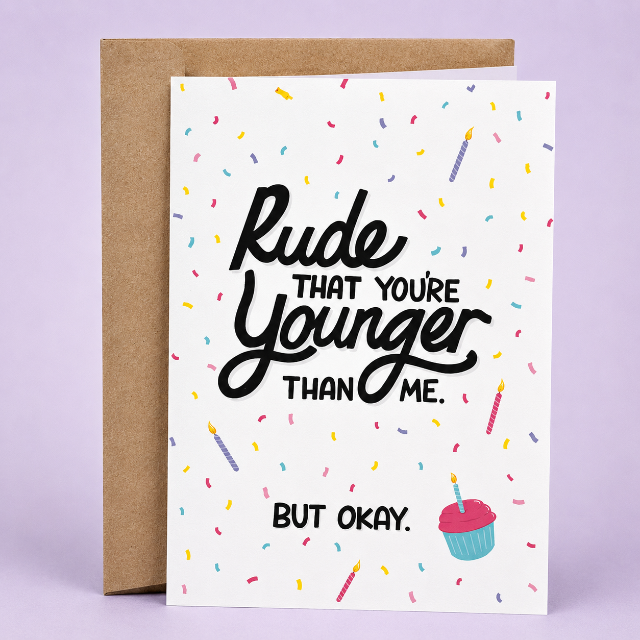 Sleazy Greetings funny birthday card featuring colorful confetti, birthday candles, and a cupcake on a white background, with the relatable message “Rude That You’re Younger Than Me. But Okay.” paired with a kraft envelope.