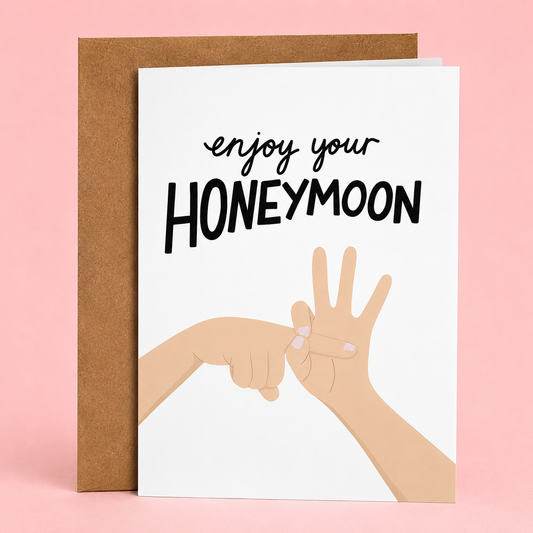 Sleazy Greetings funny wedding card featuring two hands making a playful finger gesture on a white background, with the cheeky message “Enjoy Your Honeymoon,” paired with a kraft envelope.