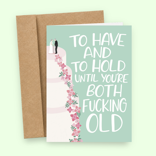 Sleazy Greetings funny wedding card featuring a tall floral wedding cake with a bride and groom topper on a soft green background, with the sarcastic marriage message “To Have and To Hold Until You’re Both Fucking Old,” paired with a kraft envelope.