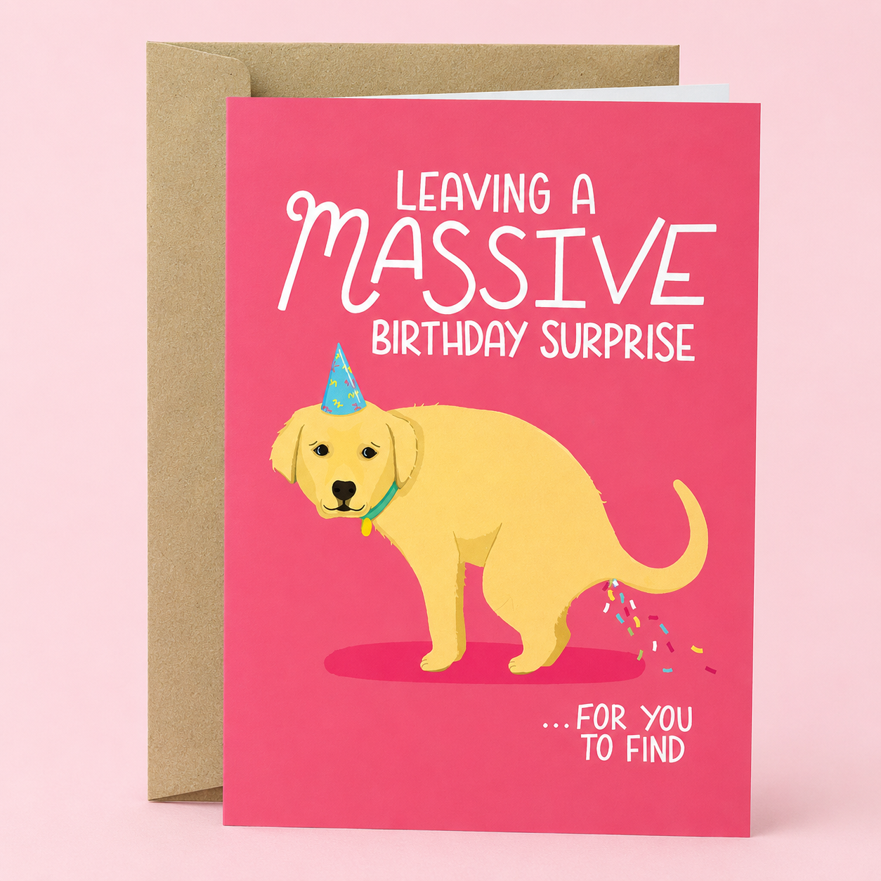 Sleazy Greetings funny birthday card featuring a guilty-looking golden retriever puppy wearing a party hat on a pink background, with the poop joke “Leaving a Massive Birthday Surprise… For You To Find,” paired with a kraft envelope.