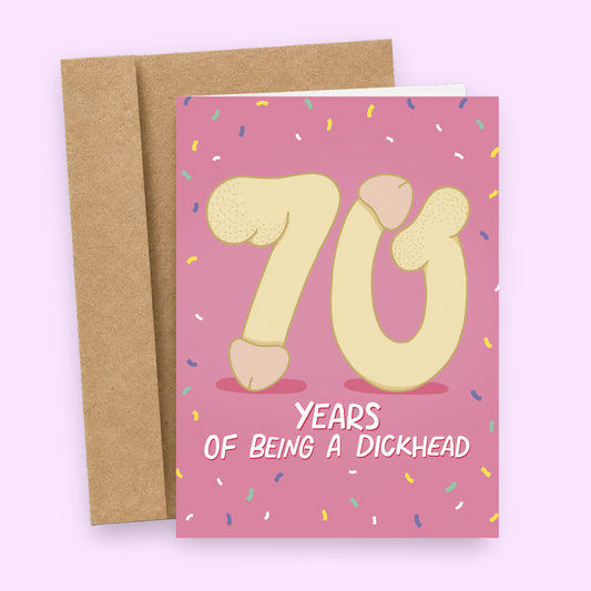 Sleazy Greetings funny 70th birthday card featuring the number “70” illustrated with cartoon penis and butt elements on a bright pink confetti background, with the message “70 Years of Being a Dickhead,” paired with a kraft envelope.